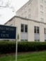 Department of State sign in front of Harry S Truman Department of State building in Washington, DC on an overcast day.