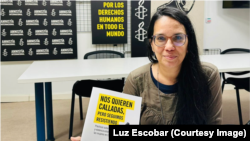 La periodista Luz Escobar con una copia del informe de Amnistía Internacional "Nos quieren calladas, pero seguimos resistiendo". 